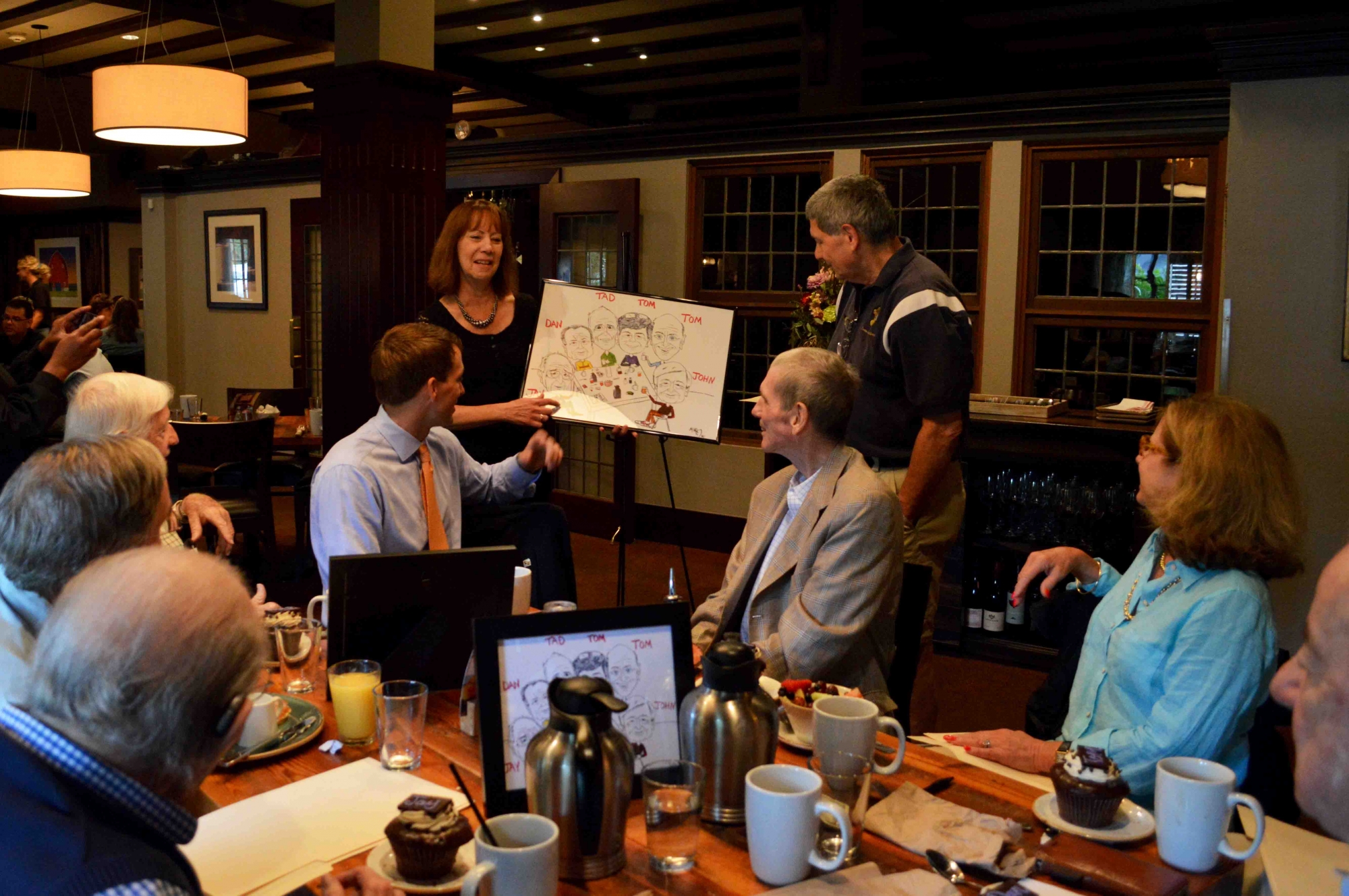 The National Exemplar's Lisa Hopkins presents the group with a caricature made just for them.